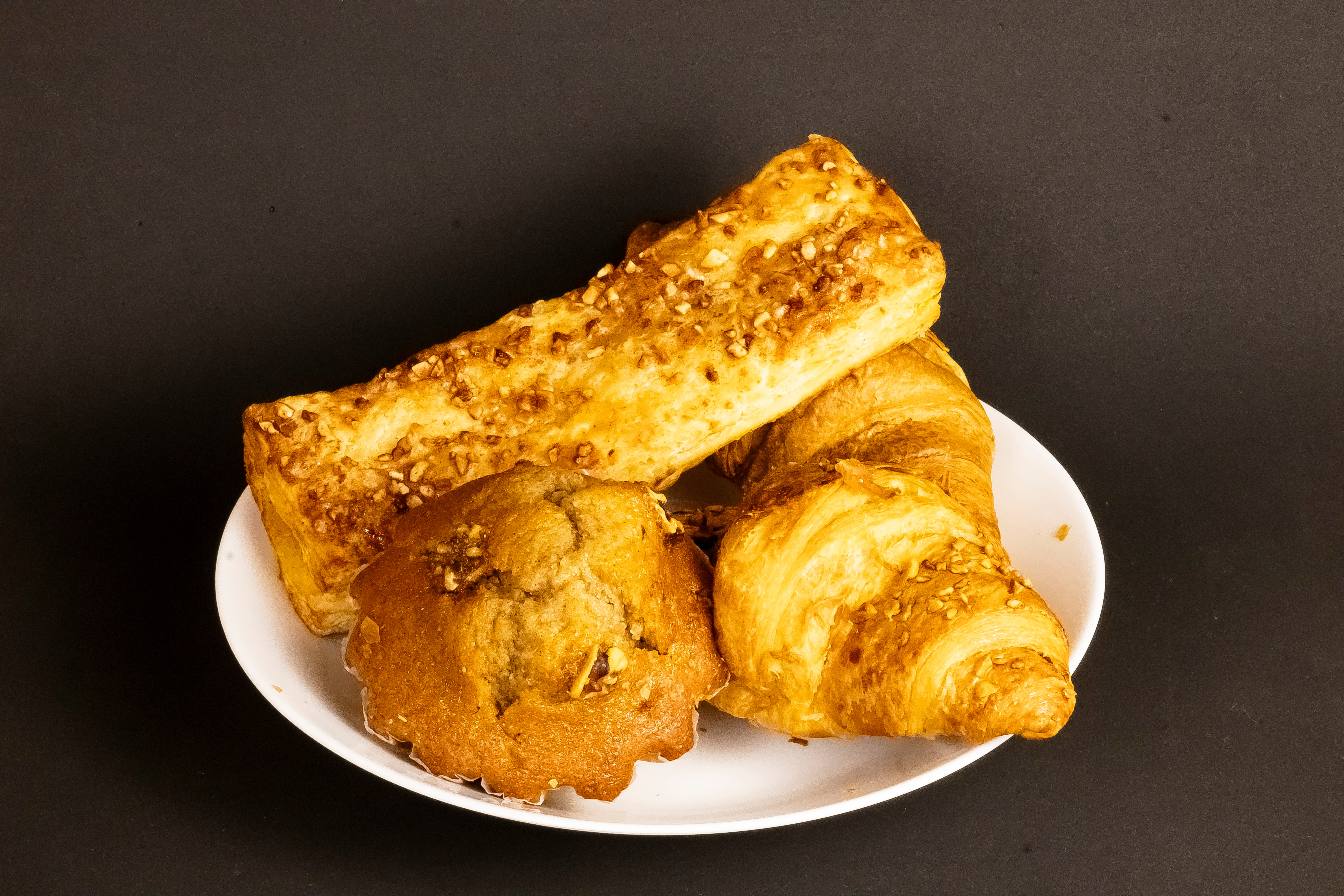 Photograph of different pastries piled onto a white plate.